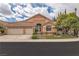 Charming home with stone accents, a three-car garage, and a well-manicured lawn under a bright sky at 1501 Via Salaria Ct, Henderson, NV 89052