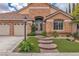 Charming home with a brick facade, well-manicured lawn, and a spacious three-car garage at 1501 Via Salaria Ct, Henderson, NV 89052