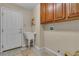 Laundry room with a utility sink, cabinets and access to the garage at 1501 Via Salaria Ct, Henderson, NV 89052