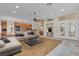 Open concept living space featuring tile and carpet flooring, fireplace, and ample natural light at 1501 Via Salaria Ct, Henderson, NV 89052