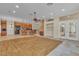 Open-concept living space featuring tile and carpet flooring, wet bar, and access to the patio at 1501 Via Salaria Ct, Henderson, NV 89052