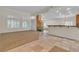 Open-concept living space with tile and carpet flooring, stone fireplace, and a wet bar area at 1501 Via Salaria Ct, Henderson, NV 89052