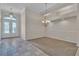Inviting living room with decorative chandelier, tile floor, and double door front entrance at 1501 Via Salaria Ct, Henderson, NV 89052