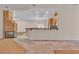 A view of the fireplace, wet bar, and kitchen from the expansive living room at 1501 Via Salaria Ct, Henderson, NV 89052