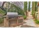 Built-in outdoor grill with stainless steel finish and granite countertop, set in a landscaped backyard at 1501 Via Salaria Ct, Henderson, NV 89052