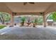 This covered patio includes an outdoor kitchen, water fountain, and textured tile at 1501 Via Salaria Ct, Henderson, NV 89052