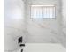 Stylish bathroom features white marble tile and modern black fixtures at 2878 El Cajon St, Las Vegas, NV 89169