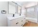 Beautiful bathroom with double vanity, modern mirrors, and stylish black fixtures at 2878 El Cajon St, Las Vegas, NV 89169