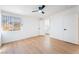 A bright bedroom has light wood floors, a ceiling fan, and leads to an adjoining bathroom and closet at 2878 El Cajon St, Las Vegas, NV 89169