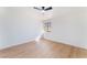 Bright bedroom with light wood floors, white walls, and a ceiling fan for a cool and serene ambiance at 2878 El Cajon St, Las Vegas, NV 89169