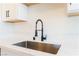 Close-up of a stainless steel kitchen sink and a modern black faucet at 2878 El Cajon St, Las Vegas, NV 89169