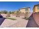 Spacious backyard featuring brick pavers and rock landscaping and a patch of turf at 320 Point Loma Ave, North Las Vegas, NV 89031
