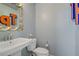Powder room with modern fixtures and a decorative mirror, offering a stylish and functional space at 320 Point Loma Ave, North Las Vegas, NV 89031