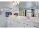 Bathroom with a dual sink vanity, large mirror, and a view of the walk-in shower at 320 Point Loma Ave, North Las Vegas, NV 89031