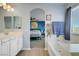 Bathroom with a vanity, a bathtub, and a doorway view of the main bedroom at 320 Point Loma Ave, North Las Vegas, NV 89031