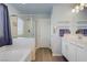 Bathroom features a walk-in shower, bathtub, and white vanity with a view into the closet at 320 Point Loma Ave, North Las Vegas, NV 89031