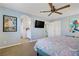 Bedroom showcasing a ceiling fan, TV, ensuite access, and wall art for a stylish look at 320 Point Loma Ave, North Las Vegas, NV 89031
