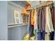 Organized walk-in closet with clothes on rods and shelves with lamp accent and storage at 320 Point Loma Ave, North Las Vegas, NV 89031