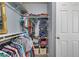 Walk-in closet showcasing organized clothes on rods and shelves, with door access at 320 Point Loma Ave, North Las Vegas, NV 89031