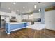 Bright kitchen with stainless steel appliances, granite countertops, and wood tile flooring at 320 Point Loma Ave, North Las Vegas, NV 89031