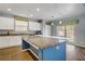 Bright kitchen featuring a large island, granite countertops, and a seamless transition to the backyard at 320 Point Loma Ave, North Las Vegas, NV 89031