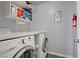Laundry room area with newer machines, extra storage and a hanging rack at 320 Point Loma Ave, North Las Vegas, NV 89031