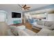 Open-concept living room flows into kitchen with stainless appliances and large island, bathed in natural light at 320 Point Loma Ave, North Las Vegas, NV 89031