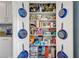Pantry with pantry doors with decorative cookware and fully stocked shelves for optimal organization at 320 Point Loma Ave, North Las Vegas, NV 89031