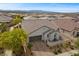 Aerial view of house featuring a paved driveway, two-car garage, and desert landscaping at 605 Cadence Vista Dr, Henderson, NV 89011