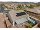 Aerial view showcases a backyard featuring a covered patio and hot tub with desert surroundings at 605 Cadence Vista Dr, Henderson, NV 89011