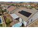 Aerial view showcases a backyard featuring a covered patio and hot tub with desert surroundings at 605 Cadence Vista Dr, Henderson, NV 89011