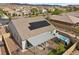 Aerial view showcasing the backyard with an in-ground spa and covered patio in a modern home at 605 Cadence Vista Dr, Henderson, NV 89011