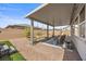 Inviting backyard patio with a covered area, brick flooring, and well-maintained desert landscaping at 605 Cadence Vista Dr, Henderson, NV 89011