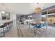 Open floor plan with stylish dining area adjacent to a modern kitchen and bright living space at 605 Cadence Vista Dr, Henderson, NV 89011