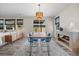 Stylish dining area features a wood table, blue chairs, and a unique chandelier at 605 Cadence Vista Dr, Henderson, NV 89011