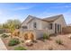 Charming single-story home featuring a well-manicured desert landscape and a private courtyard wall at 605 Cadence Vista Dr, Henderson, NV 89011