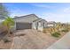 Charming home featuring a well-maintained yard, a two-car garage, and a paved driveway at 605 Cadence Vista Dr, Henderson, NV 89011