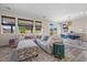 Spacious living room with a large sectional sofa, and views of the dining room and kitchen at 605 Cadence Vista Dr, Henderson, NV 89011