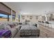 Open concept living room with plush sectional sofa, lots of natural light and views into the kitchen at 605 Cadence Vista Dr, Henderson, NV 89011