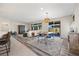 Bright living room boasts wood floors, contemporary furniture, and a sliding glass door to the backyard at 605 Cadence Vista Dr, Henderson, NV 89011