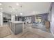Bright, open-concept living area featuring a modern kitchen, dining space, and a comfortable seating area at 605 Cadence Vista Dr, Henderson, NV 89011