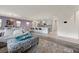 Open-concept living space with kitchen island, comfortable seating area, and neutral decor at 605 Cadence Vista Dr, Henderson, NV 89011
