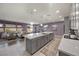 Spacious open-concept living room with modern decor, kitchen with large island, and ample natural light at 605 Cadence Vista Dr, Henderson, NV 89011