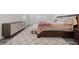 Comfortable main bedroom featuring cozy bedding, a soft rug, and a stylish dresser at 605 Cadence Vista Dr, Henderson, NV 89011