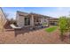 Landscaped backyard patio with a pergola, outdoor seating, a hot tub, and desert landscaping at 605 Cadence Vista Dr, Henderson, NV 89011