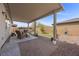 Covered patio featuring brick pavers, outdoor seating, desert landscaping, and a luxurious hot tub at 605 Cadence Vista Dr, Henderson, NV 89011