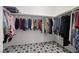 Walk-in closet with an abundance of hanging storage and star-patterned tile flooring at 605 Cadence Vista Dr, Henderson, NV 89011