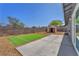 Private backyard featuring an artificial grass area, gravel accents, shed and concrete patio at 6770 Laronda Ln, Las Vegas, NV 89156