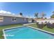 Staged backyard featuring a sparkling swimming pool and outdoor seating, ideal for entertaining and relaxation at 6770 Laronda Ln, Las Vegas, NV 89156