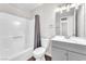 Bathroom featuring shower and tub combination, gray vanity and a large mirror at 6770 Laronda Ln, Las Vegas, NV 89156